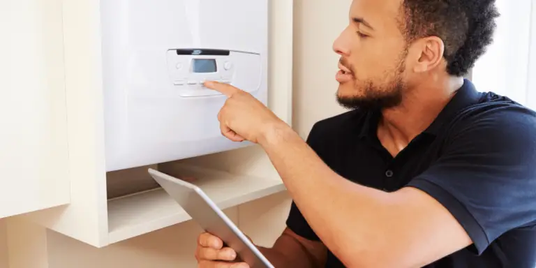 man installing new boiler working out cost